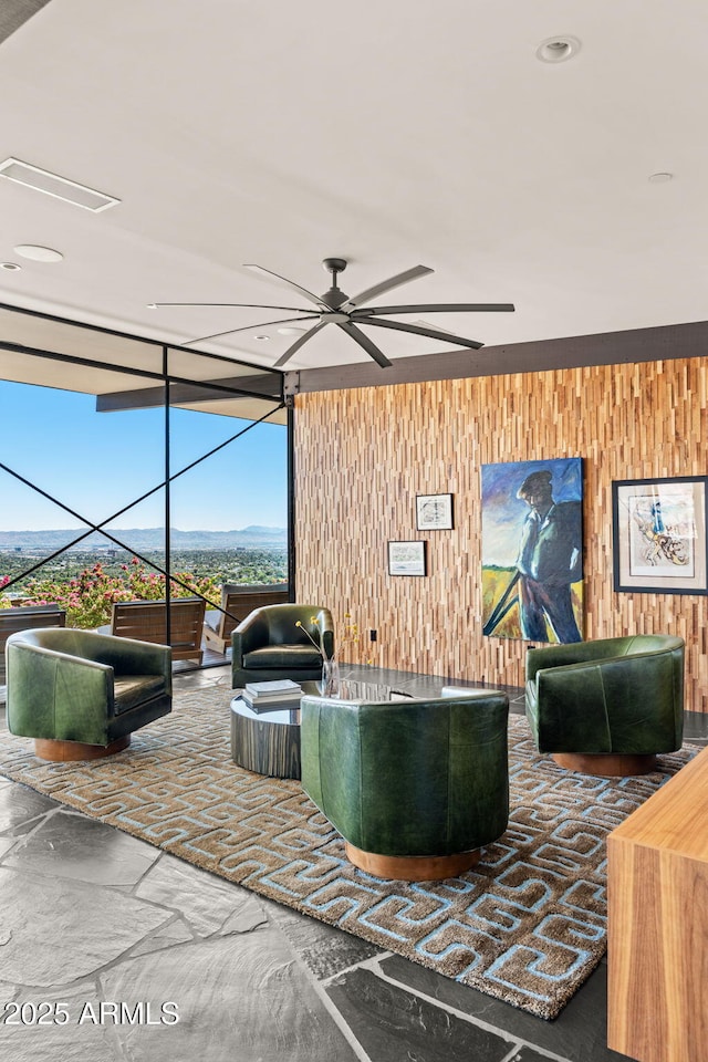4925 E Red Rock Dr Unit 43, Phoenix, AZ 85018 - living room featuring wood walls, ceiling fan, and expansive windows