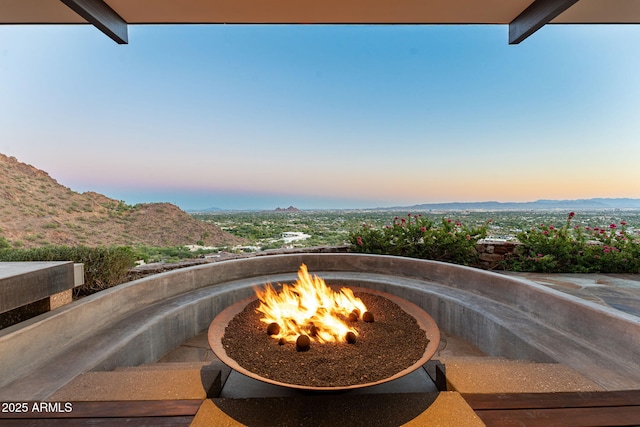 4925 E Red Rock Dr Unit 43, Phoenix, AZ 85018 - patio terrace at dusk with an outdoor fire pit and a mountain view