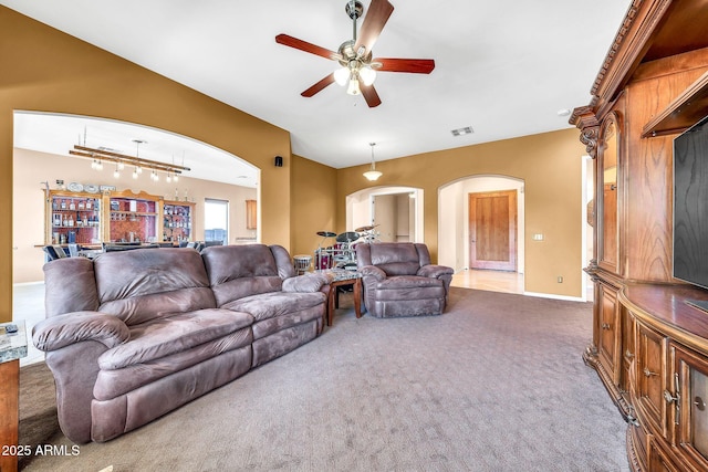 747 E Meadow Ln, Phoenix, AZ 85022 - carpeted living area with baseboards, arched walkways, a ceiling fan, and rail lighting