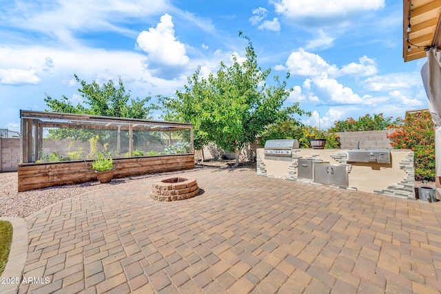 747 E Meadow Ln, Phoenix, AZ 85022 - view of patio / terrace with area for grilling, exterior kitchen, a sink, fence, and an outdoor fire pit