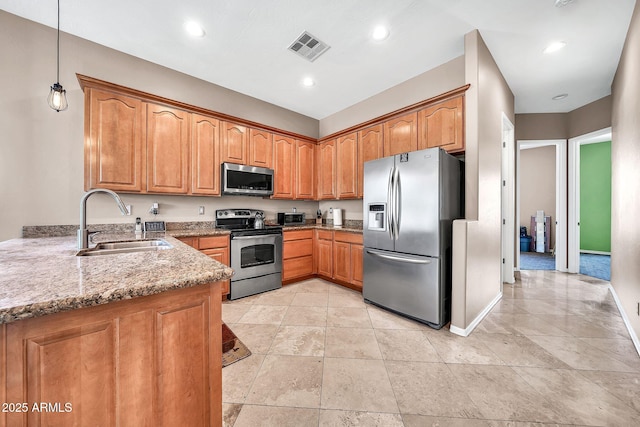 747 E Meadow Ln, Phoenix, AZ 85022 - kitchen with visible vents, light stone countertops, brown cabinets, a sink, and stainless steel appliances