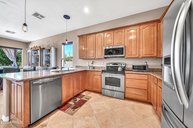 747 E Meadow Ln, Phoenix, AZ 85022 - kitchen featuring visible vents, a peninsula, a sink, a wealth of natural light, and stainless steel appliances