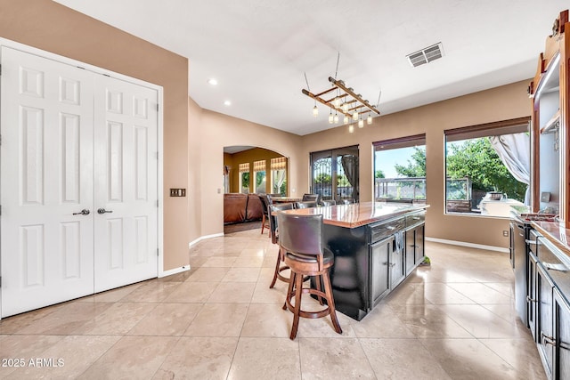 747 E Meadow Ln, Phoenix, AZ 85022 - dining space with visible vents, arched walkways, baseboards, and a healthy amount of sunlight