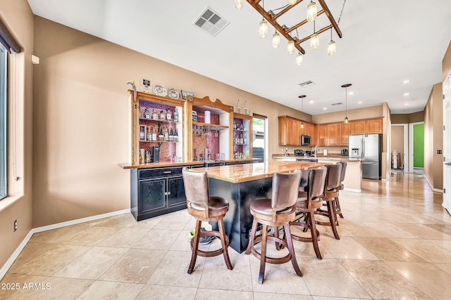 747 E Meadow Ln, Phoenix, AZ 85022 - interior space with visible vents, baseboards, hanging light fixtures, and stainless steel appliances