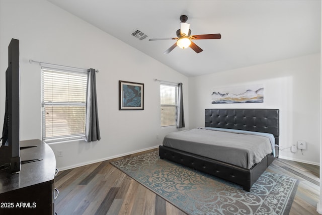 bedroom featuring lofted ceiling, visible vents, ceiling fan, wood finished floors, and baseboards