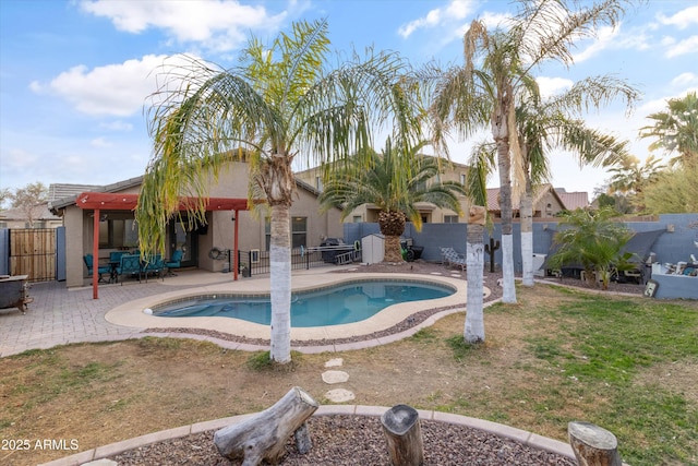 view of pool featuring a fenced in pool, a fenced backyard, and a patio