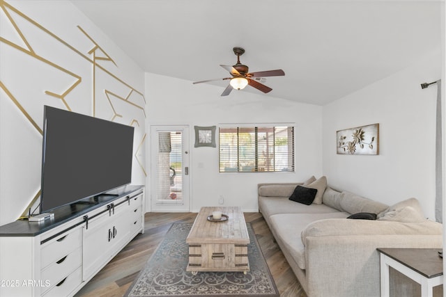 living room with lofted ceiling, wood finished floors, and a ceiling fan