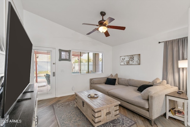 living area featuring vaulted ceiling, ceiling fan, and wood finished floors