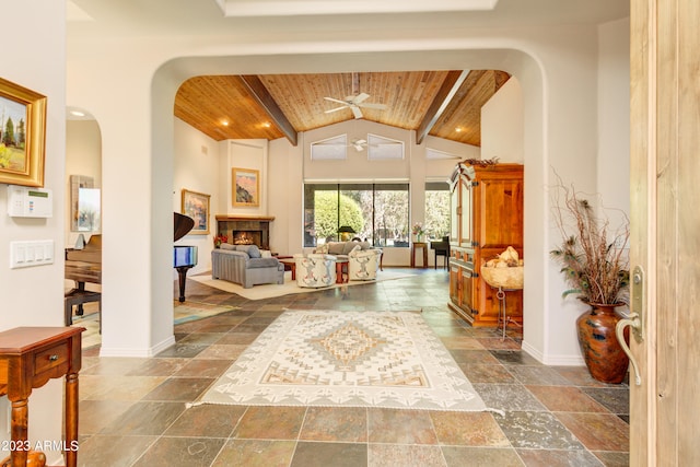 entryway with wood ceiling, high vaulted ceiling, beamed ceiling, and ceiling fan