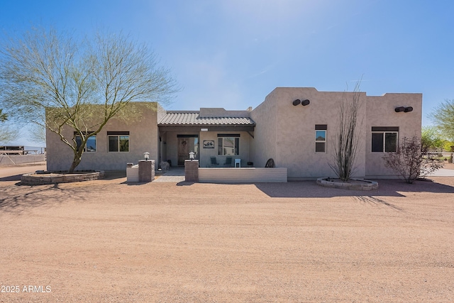 view of front of property with a tiled roof and stucco siding