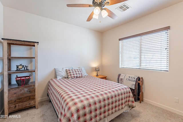 bedroom with light carpet, ceiling fan, visible vents, and baseboards