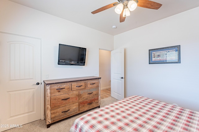 bedroom with a ceiling fan and light carpet