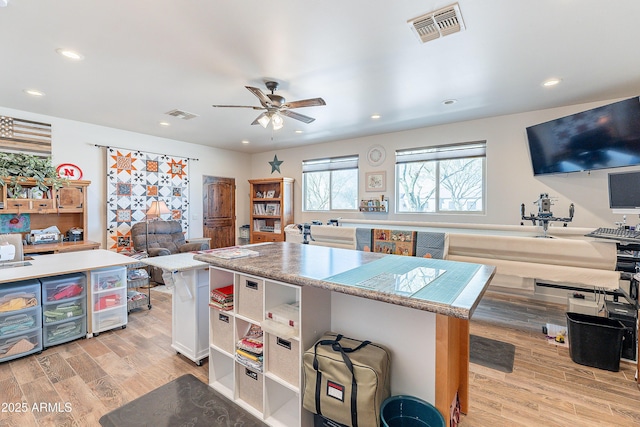 kitchen with light wood-type flooring, open floor plan, visible vents, and recessed lighting