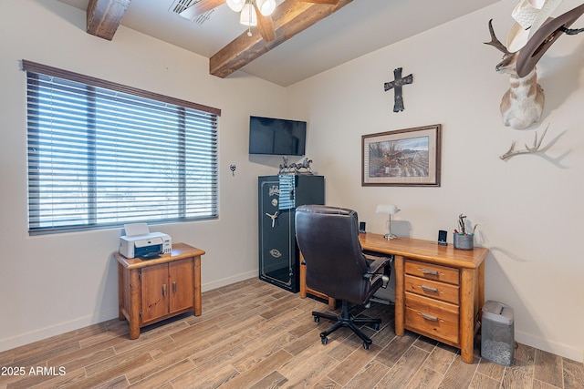 office featuring visible vents, baseboards, a ceiling fan, light wood-style flooring, and vaulted ceiling with beams