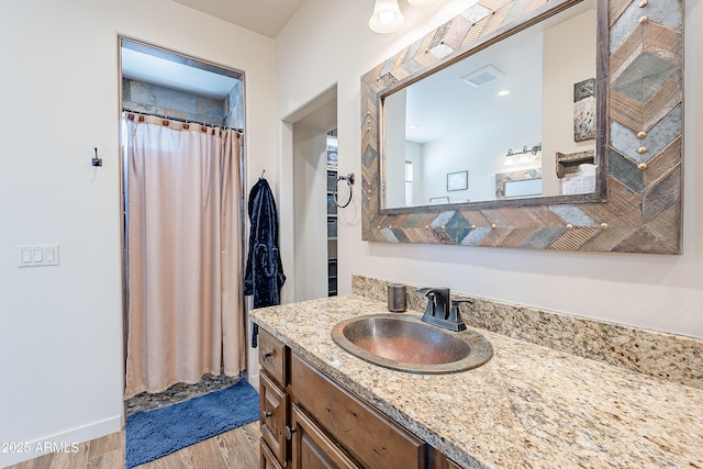 bathroom with curtained shower, visible vents, wood finished floors, and vanity