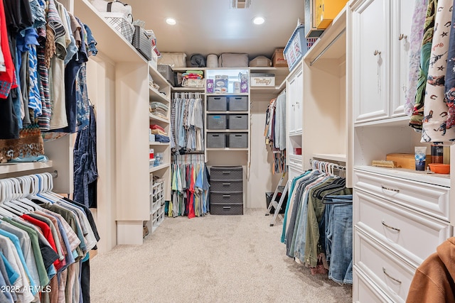 walk in closet featuring carpet floors and visible vents