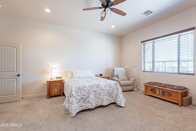 bedroom featuring baseboards, visible vents, and light colored carpet