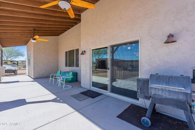 view of patio with a grill and ceiling fan