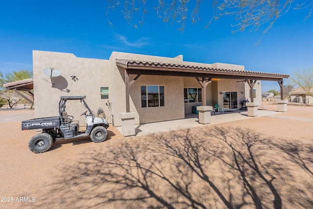 back of house featuring a patio area, ceiling fan, a tiled roof, and stucco siding