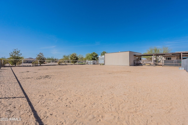 view of yard featuring an outbuilding and an exterior structure