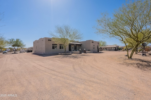 view of front facade featuring driveway and stucco siding