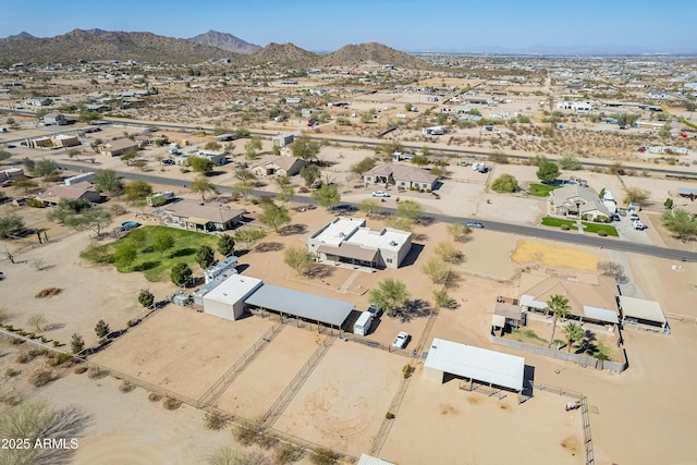 birds eye view of property featuring view of desert and a mountain view