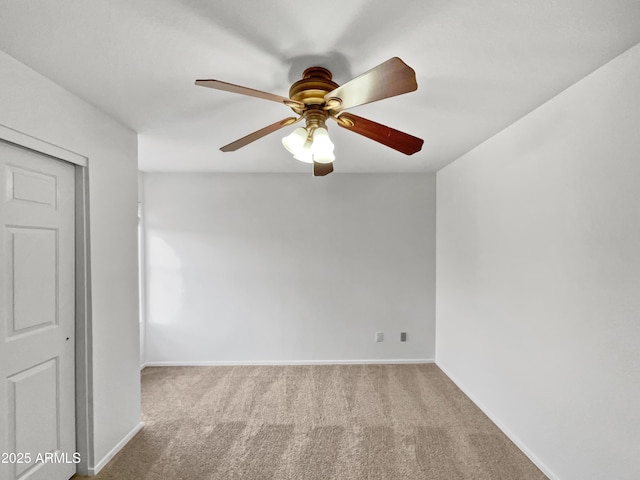 carpeted empty room featuring ceiling fan