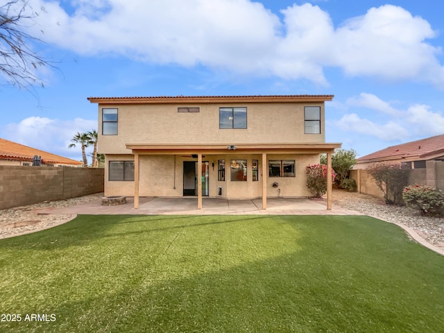 rear view of property with a yard and a patio area