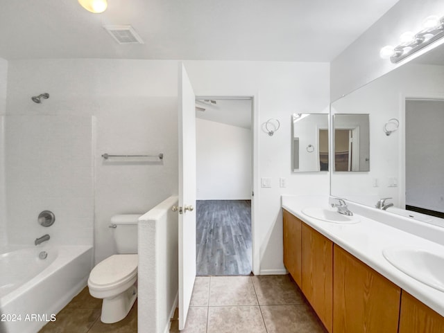 full bathroom featuring bathtub / shower combination, vanity, toilet, and tile patterned flooring