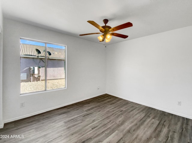 unfurnished room with dark hardwood / wood-style floors and ceiling fan