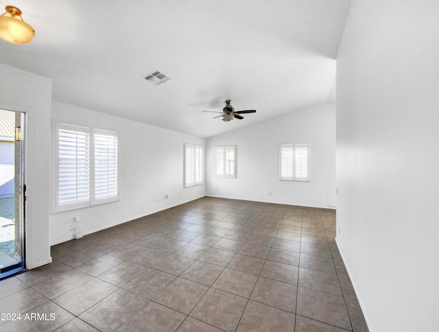 unfurnished room featuring lofted ceiling, ceiling fan, and tile patterned flooring