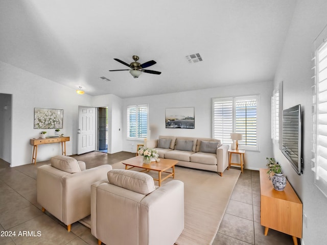 tiled living room with ceiling fan, a healthy amount of sunlight, and lofted ceiling