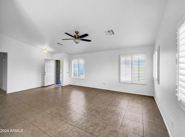 unfurnished room with tile patterned flooring, plenty of natural light, and ceiling fan