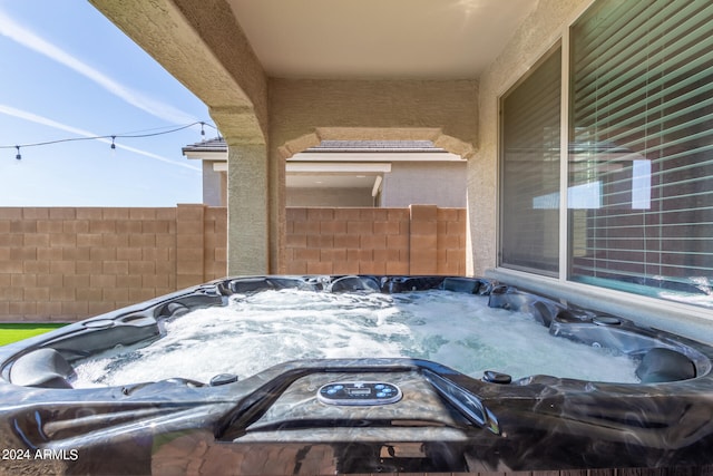 view of patio / terrace with a hot tub