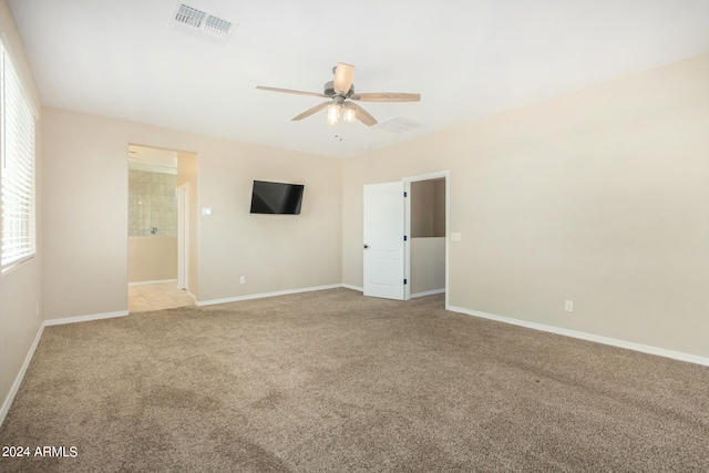 unfurnished room with light colored carpet and ceiling fan