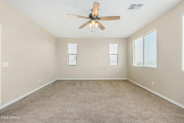 unfurnished room featuring ceiling fan and carpet