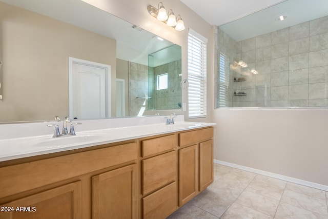 bathroom featuring vanity, tile patterned flooring, and a tile shower