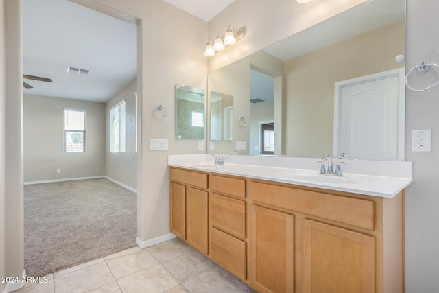 bathroom with ceiling fan, tile patterned flooring, and vanity