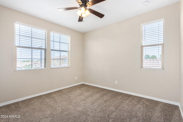 empty room featuring carpet flooring and ceiling fan