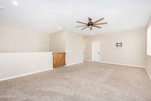 spare room featuring ceiling fan and carpet flooring