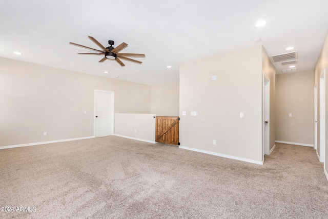 spare room with light carpet and ceiling fan