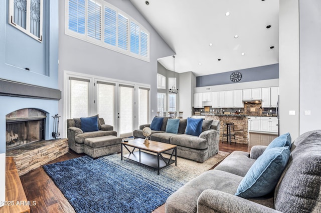 living room with wood-type flooring, a wealth of natural light, and a chandelier