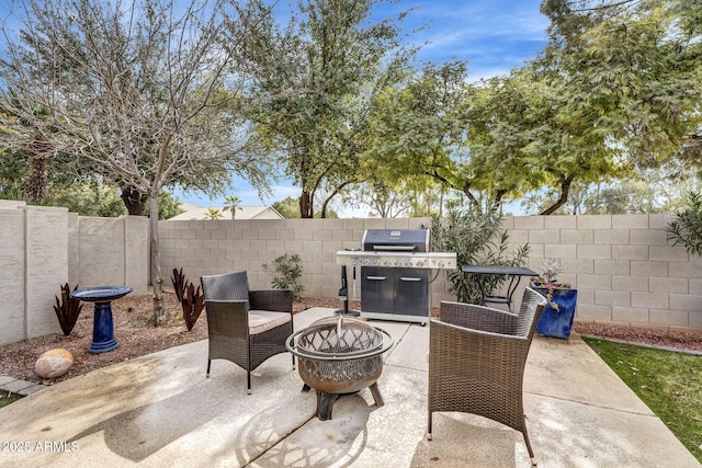 view of patio featuring area for grilling and an outdoor fire pit