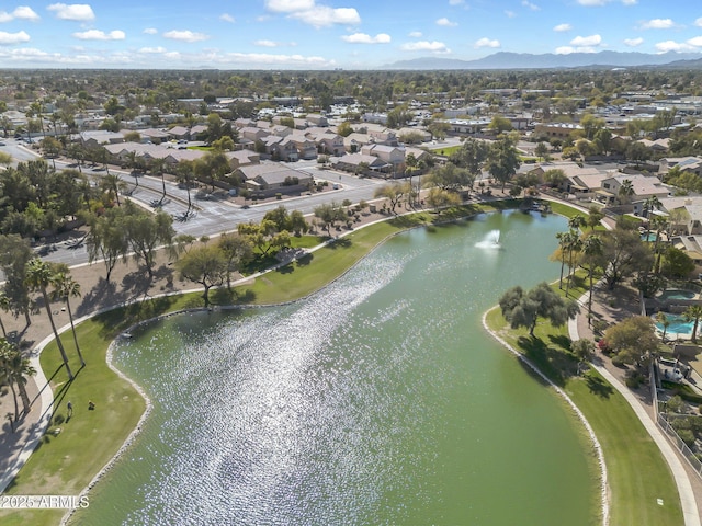 birds eye view of property with a water and mountain view