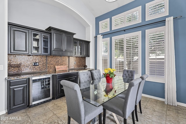 dining space with wine cooler and bar area