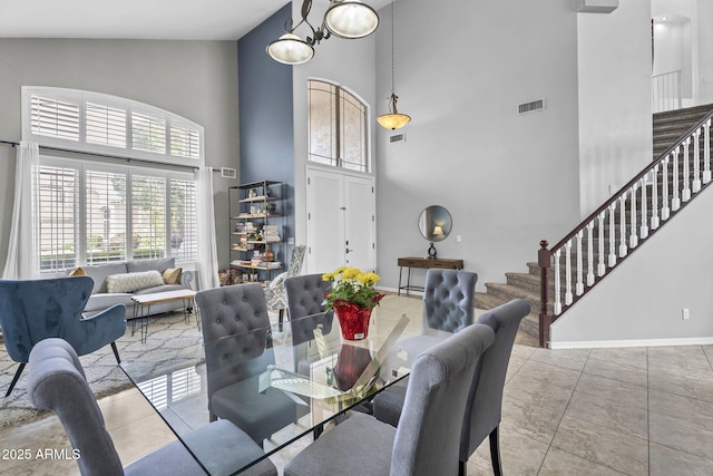 dining space featuring a high ceiling and light tile patterned floors