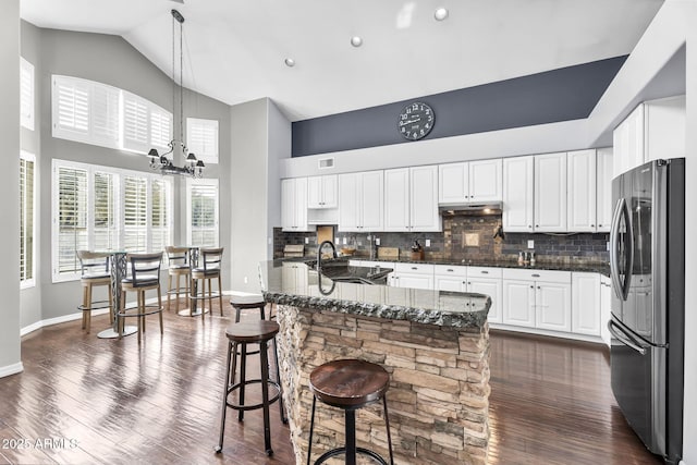 kitchen featuring sink, stainless steel fridge, dark hardwood / wood-style floors, and white cabinets