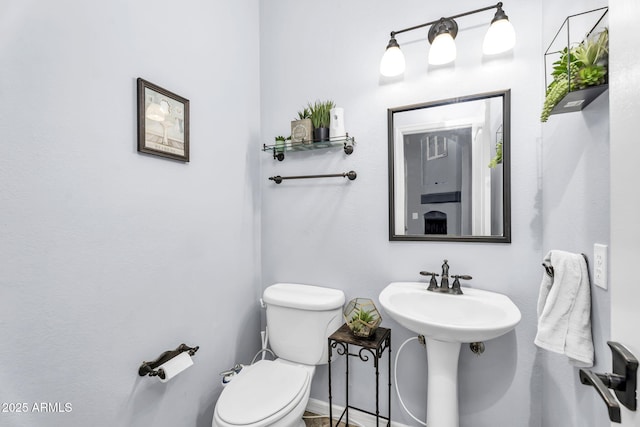 bathroom with toilet and sink