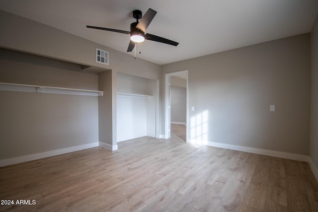 unfurnished bedroom with a closet, light hardwood / wood-style flooring, and ceiling fan