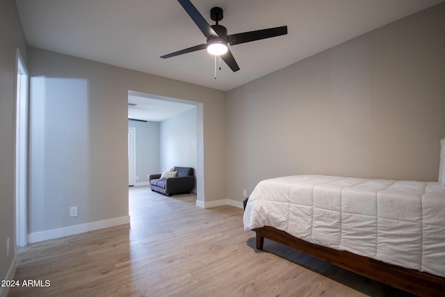 bedroom with ceiling fan and light hardwood / wood-style flooring